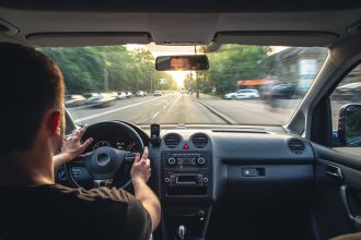 mains sur le volant d'une voiture
